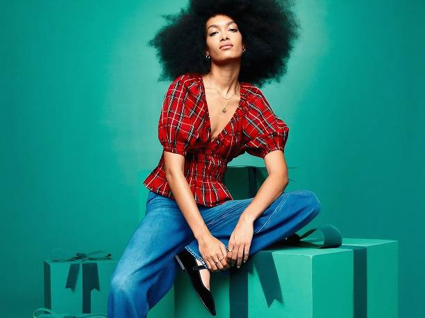 Woman posing on green gift boxes