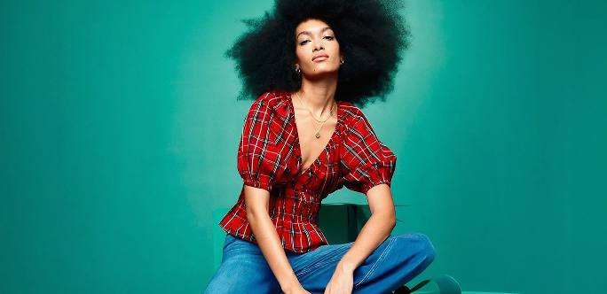 Woman posing on green gift boxes